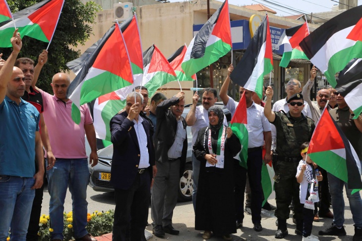A march in Qalqilya to raise the Palestinian flag