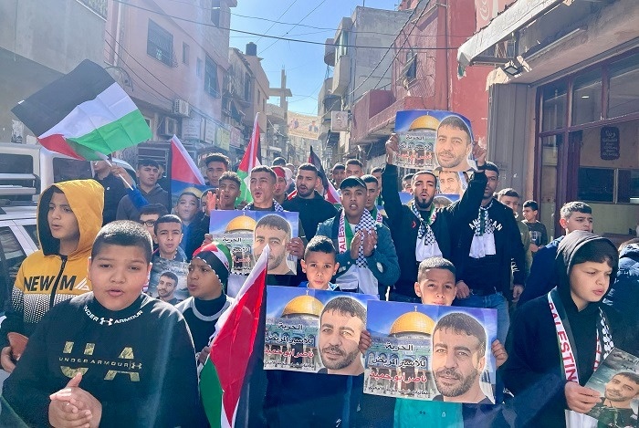 A march in Al-Amari camp calling for the freedom of the sick prisoner, Nasser Abu Hamid