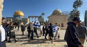 Settlers raise the Israeli flag at Al-Aqsa Mosque